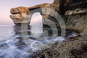 A beautiful early morning landscape photograph of the famous Azure Window rock arch