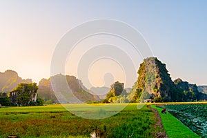 Beautiful early sunset as tourists flock to Hang Mua to take photos around the lilypads against the beautiful landscape