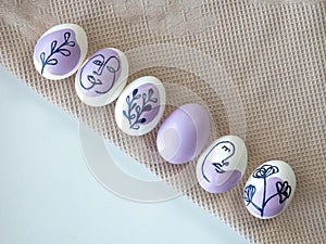 Beautiful Easter eggs on a kitchen towel, purple pattern.