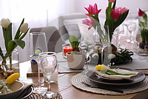 Beautiful Easter table setting with beautiful flowers indoors