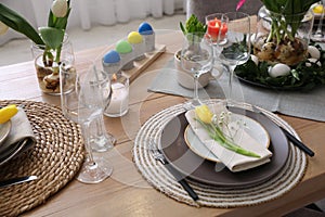 Beautiful Easter table setting with beautiful flowers indoors