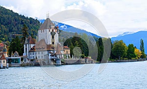 A beautiful edifice stands gracefully on bank of a lake in Thun City, Switzerland