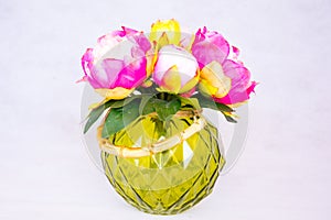 Beautiful Ekibana of peonies flowers in a green vase