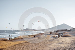 Beach with kite surfers on a sunset