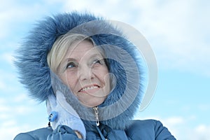 Beautiful elderly woman smiling against the sky