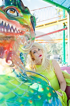 Beautiful elegant blonde fashion woman portrait in amusement park summer