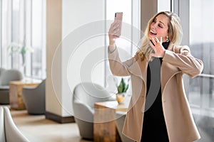 Beautiful and elegant business woman at using video chat to connect with her family while at work
