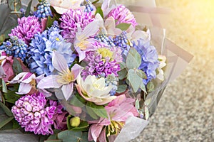 Beautiful elegant designer pink purple blue bouquet of florist with different flowers close-up. Floral background