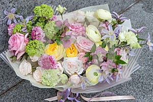 Beautiful elegant designer white yellow pink wedding bouquet of florist with roses closeup