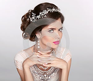 Beautiful elegant girl model with jewelry, makeup and retro hair styling. Manicured nails. photo