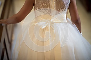 a beautiful and elegant large white bow on the back of this brides dress
