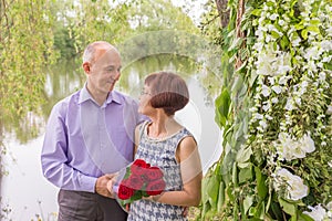 Beautiful elegant middle-aged couple posing smiling