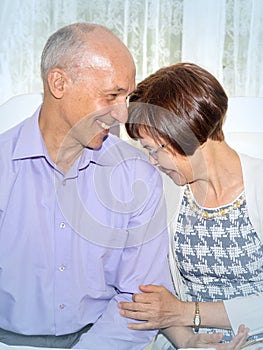 Beautiful elegant middle-aged couple posing smiling