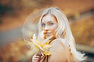 Beautiful elegant woman in autumn leaf park.