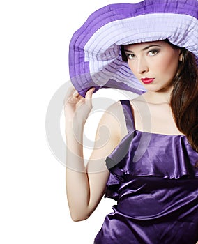 Beautiful elegant woman in a lilac hat