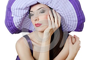 Beautiful elegant woman in a lilac hat