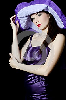 Beautiful elegant woman in a lilac hat