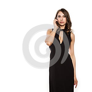 Beautiful elegant woman posing in long black dress on a white background. free space for your text