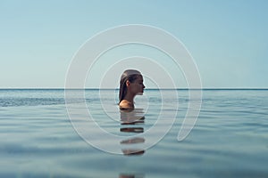 Beautiful elegant woman in the sea