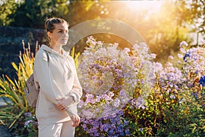 Beautiful elegant woman standing in autumn park with yellow leaves outdoor. Beauty Romantic Girl Outdoors enjoy autumn