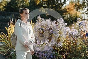 Beautiful elegant woman standing in autumn park with yellow leaves outdoor. Beauty Romantic Girl Outdoors enjoy autumn