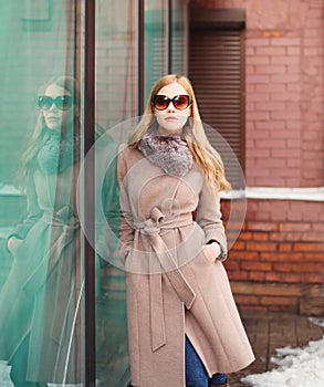 Beautiful elegant woman wearing a coat jacket and sunglasses