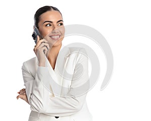 beautiful elegant woman in white suit having a phone conversation