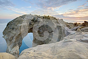 Beautiful elephant-like rock formation under twilight sky at rocky seashore in northern Taiwan