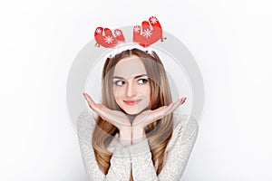 Beautiful emotional blonde female model wear santa deer headpiece. Christmas greetings concept.