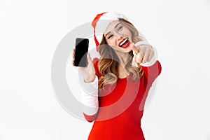 Beautiful emotional woman in christmas costume showing display of mobile phone