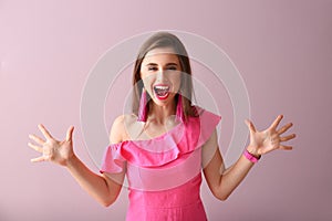 Beautiful emotional young woman on color background