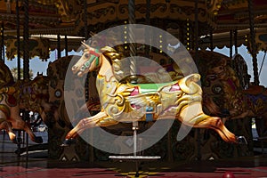 Beautiful empty colorful horse on a merry go round attraction