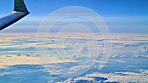 Beautiful endless panorama from the height of flying airplane above the clouds