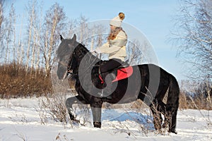 Beautiful equestrian girl ride horse  in winter countryside