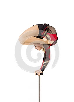 Beautiful equilibrist in a red and black suit, performs exercises on acrobatic canes