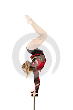 Beautiful equilibrist in a red and black suit, performs exercises on acrobatic canes