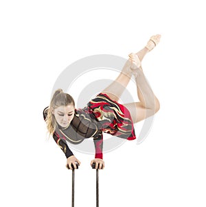 Beautiful equilibrist in a red and black suit, performs exercises on acrobatic canes