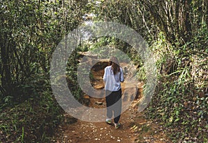 Beautiful european girl walking in the tropical forest