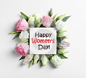 Beautiful Eustoma flowers and card on white background, flat lay. Happy Women`s Day