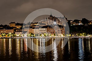 Beautiful evening cityscape view with water reflections. Old buildings on Sodermalm in Stockholm Sweden.