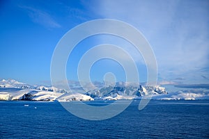 Antarctic landscape with snowcapped mountains and glacier near Andvor Bay, Antactic Peninsular photo