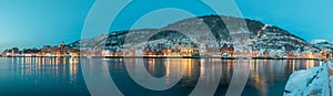 Beautiful evening panorama of Bergen waterfront, Bryggen area. Magical wide cityscape at night, covering the whole bay of Bergen.