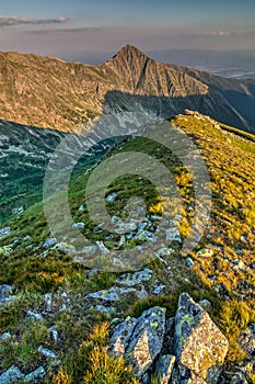 Beautiful evening on ridge of the summer mountains