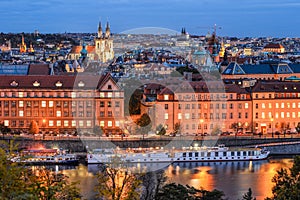 Beautiful evening roof view on Tyn Church, Vltava river and Old Town Square, Prague, Czech Republic.