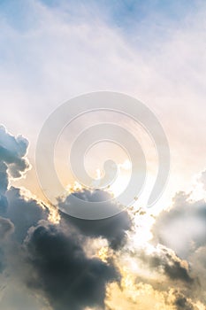 Beautiful evening skyscape. Sun`s rays shine through hole in black clouds after rain