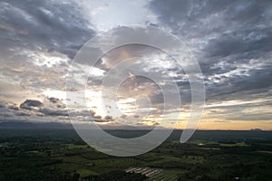 Beautiful evening sun gray clouds covered with green forest, Sky background