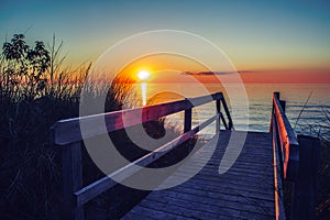 Beautiful evening sunset landscape at Canadian Ontario lake Huron in Pinery Park, orange blue red sky sun