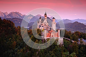 Beautiful evening view of the Neuschwanstein castle, with autumn colours after sunset, Bavarian Alps, Bavaria, Germany