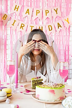 Beautiful excited woman celebrating birthday party making wish