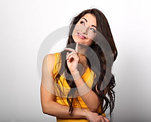 Beautiful excited young smiling woman with finger under the face